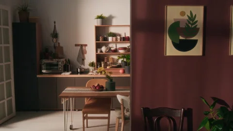 Two Pictures on Burgundy Wall, Dining Area with Kitchen Set and Appliances Stock Footage 302904688