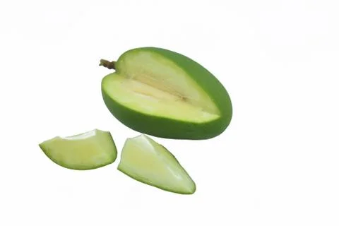 Two piece of a sliced mango placed beside the rest of the pieces of the mango Stock Photos