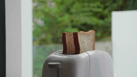 Two pieces of bread jump out of the toaster. Close-up shot. Stock Footage 172442438