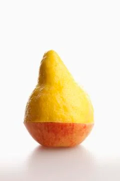 Two pieces of different fruit stacked to comprise the shape of a piece of fruit Stockfoto's