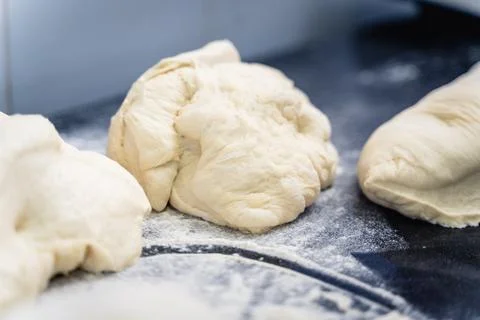Two pieces of dough are sitting on a countertop Stock Photos
