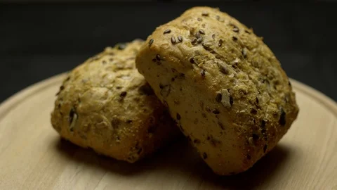 Two pieces of integral bread on a wooden board Stock Footage 106753589