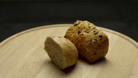 Two pieces of integral bread on a wooden board Video stock 106754296