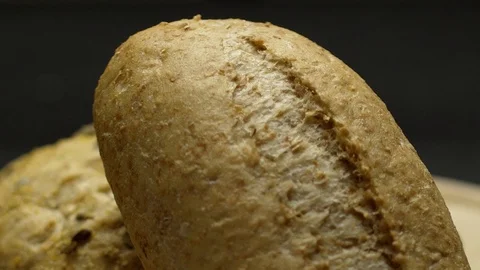 Two pieces of integral bread on a wooden board Video stock 117343556