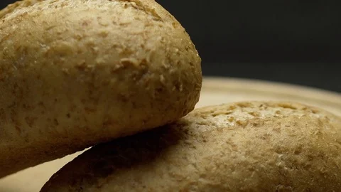 Two pieces of integral bread on a wooden board Stock Footage 117343580