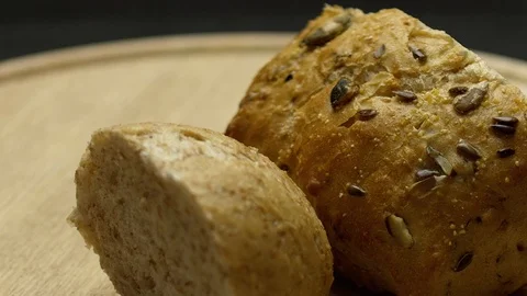 Two pieces of integral bread on a wooden board Stock Footage 117343725