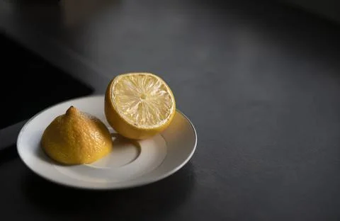 Two pieces of lemon on a plate Stock Photos