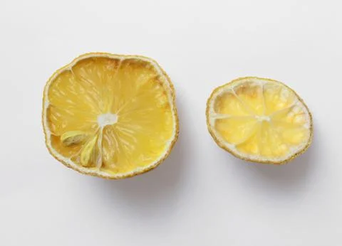 Two pieces of old drying lemon Stock Photos