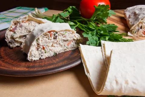 Two pieces of pita bread or lavash roll with cottage cheese or curd, chicken, Stock Photos