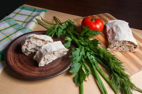 Two pieces of pita bread or lavash roll with cottage cheese or curd, chicken, Stock Photos