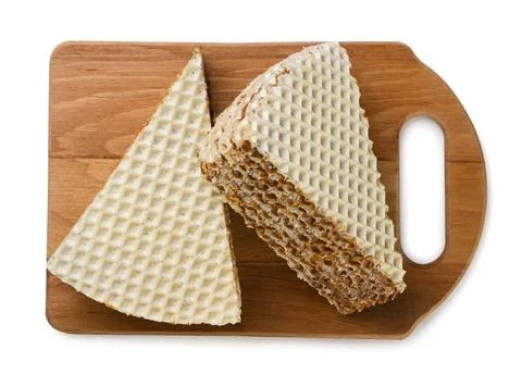 Two pieces puff waffle cake on a kitchen board on a white. Top view Stock Photos