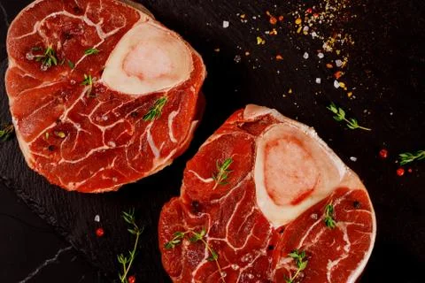 Two pieces of raw fresh beef shank bone in with spices. Stock Photos