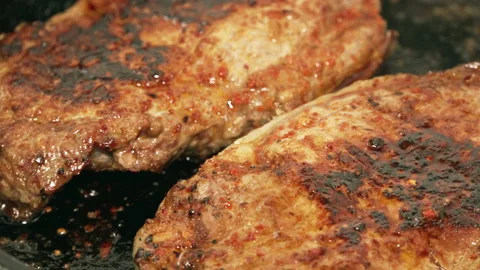 Two pieces of steak on pan rotating Stock Footage 151187613