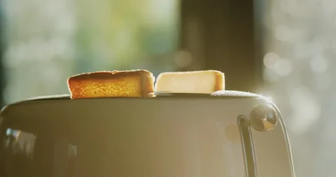 Two pieces of toasted bread jumping out of the toaster Video stock 258107972