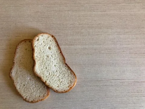 Two pieces of white bread on a light background Stock Photos