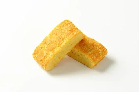 Two pieces of yellow sponge cake Stock Photos