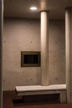 Two pillars and a black window with a white bench Stock Photos