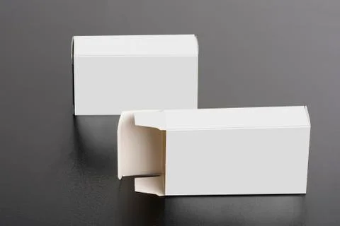 Two pillboxes packages on dark background  mock-up series Stock Photos
