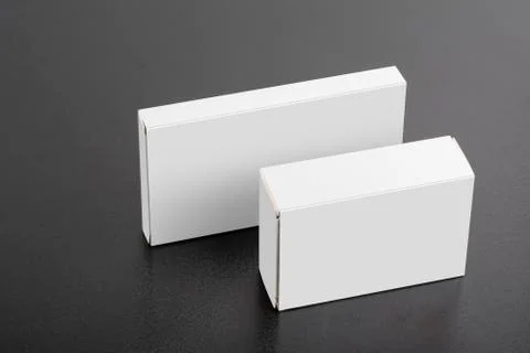 Two pillboxes packages on dark background mock-up series Stock Photos