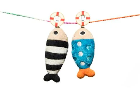 Two pillows fish shape hanging on the rope isolated on white background Foto stock