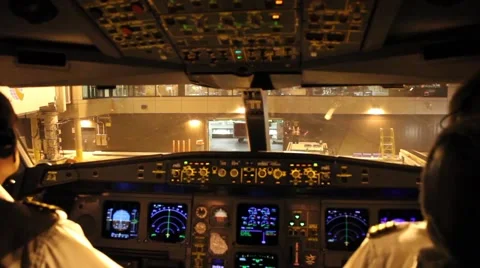 Two pilots inside a cockpit following direction from airport crew  Stock Footage 40545385
