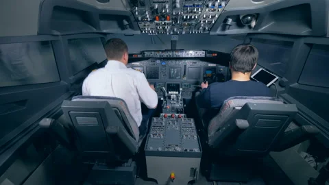 Two pilots sit in the cockpit. Video stock 88538245