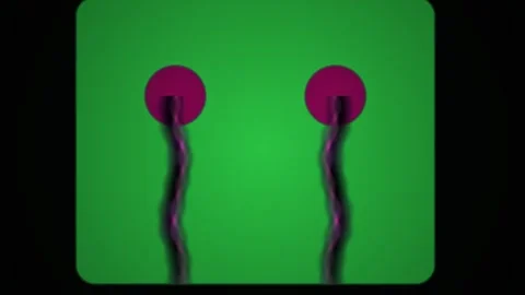 Two pink circular objects on black sticks against green background. Stock Footage 335540373