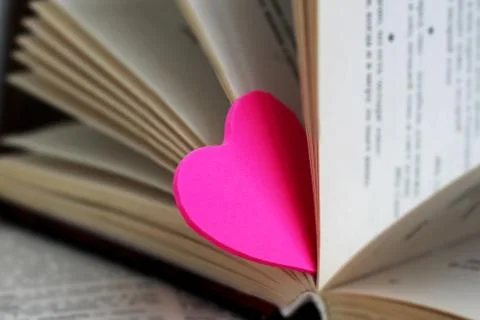 Two pink hearts and books, love and romance Stock Photos