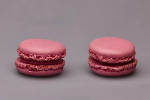 Two pink macarons side by side on gray background Stock Photos