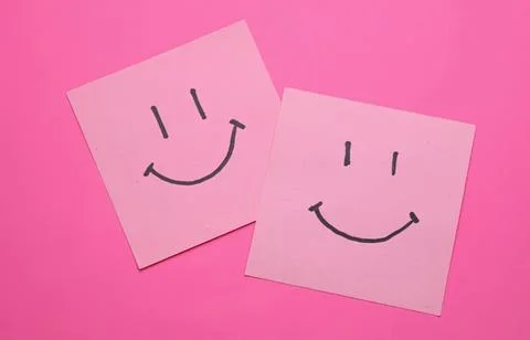 Two pink sticky notes with happy smiley faces on pink background Stock Photos