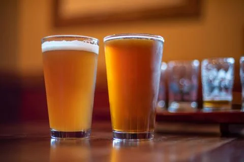 Two pints of craft beer on bar counter at night Stock Photos