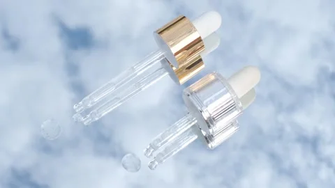 Two pipettes with serum on the background of blue sky and clouds, skin care Stock Footage 316576517