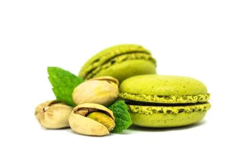 Two pistachio macarons with nuts isolated on white Stock Photos