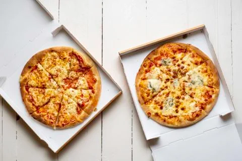 Two pizza in cardboard boxes. Sliced fresh pizza Stock Photos