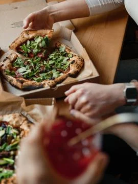 Two pizzas in boxes on a table with lemonade, romantic, delivery Stock Photos