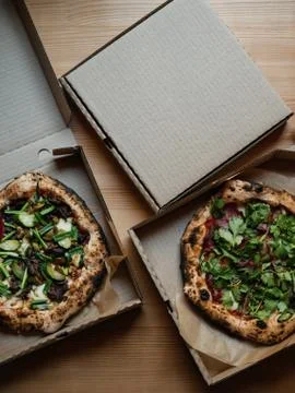 Two pizzas in boxes on a table, top view Stock Photos