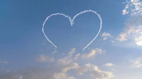 Two planes drawing a heart in the sky with smoke Stock Footage 107570241
