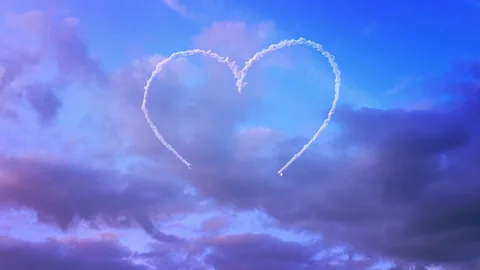 Two planes drawing a heart in the sky with smoke Stock Footage 107570772