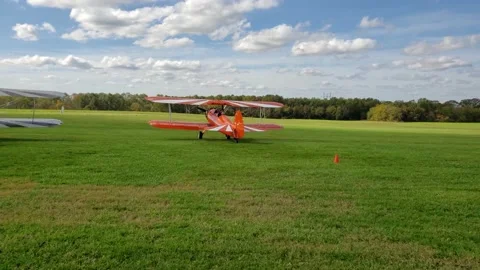 Two planes, each with a parachutist in the front seat, taxi out for takeoff Stock Footage 141531579