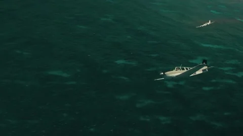 Two planes flying together over the ocean Stock Footage 259905417