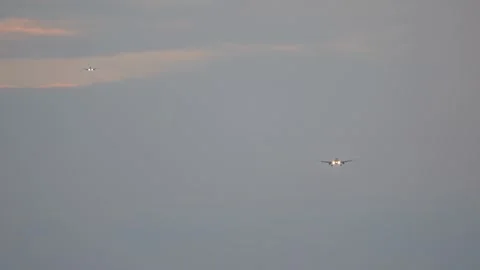 Two planes high in the sky are landing at the airport Stock Footage 246865197
