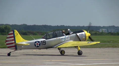 Two planes landing on a runway after acrobatic air show Stock Footage 39750403