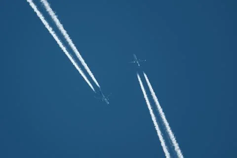 Two planes in the sky, two airplane tracks in the blue sky, contrails Stock-Fotos