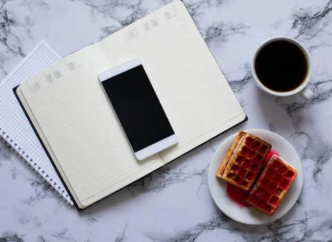 Two planners on marble background, coffee, waffles and smartphone Stock Photos
