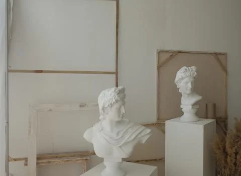 Two plaster statues of men in the interior. Art painting Stock Photos