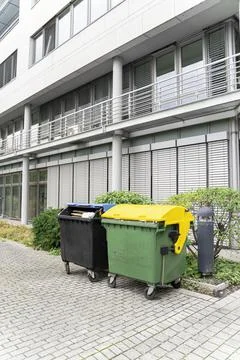 Two plastic clean garbage containers black and green-yellow for separate waste 스톡 사진