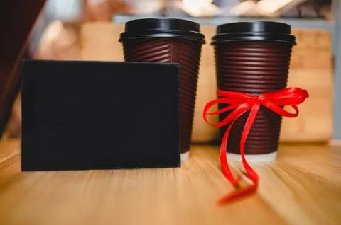 Two plastic coffee cups with a black plate Stock Photos