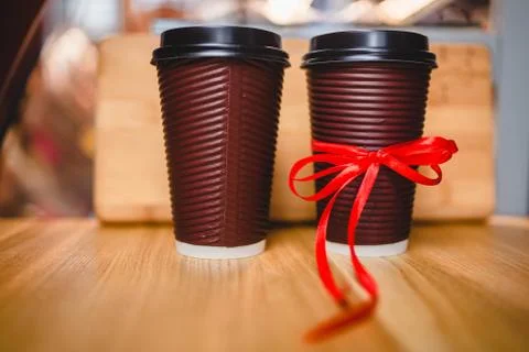 Two plastic cups of coffee with a lid on a wooden background Stock Photos