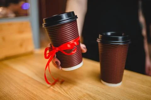 Two plastic cups of coffee with a lid on a wooden background Stock Photos