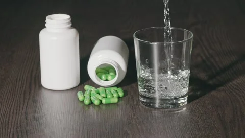 Two plastic jars with capsules on the table Stock Footage 270414017